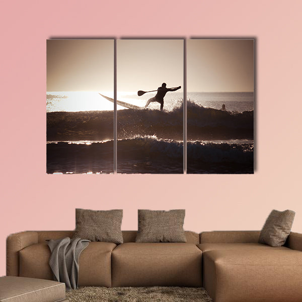 Silhouette of a man paddle boarding Multi panel canvas wall art