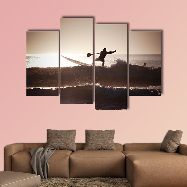 Silhouette of a man paddle boarding Multi panel canvas wall art