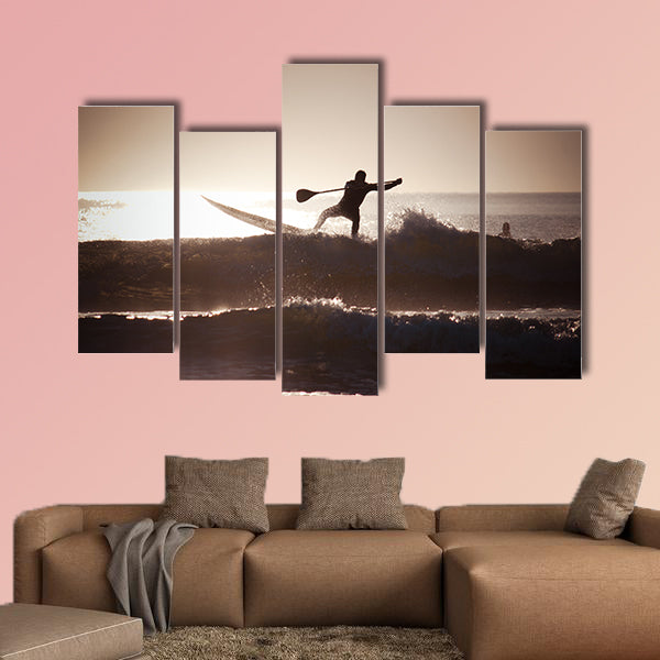 Silhouette of a man paddle boarding Multi panel canvas wall art