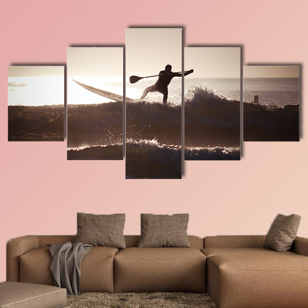 Silhouette of a man paddle boarding Multi panel canvas wall art