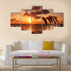 beautiful sunset with dolphins jumping multi panel canvas wall art