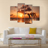 Beautiful sunset with dolphins jumping Multi Panel Canvas Wall Art