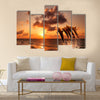 Beautiful sunset with dolphins jumping Multi Panel Canvas Wall Art