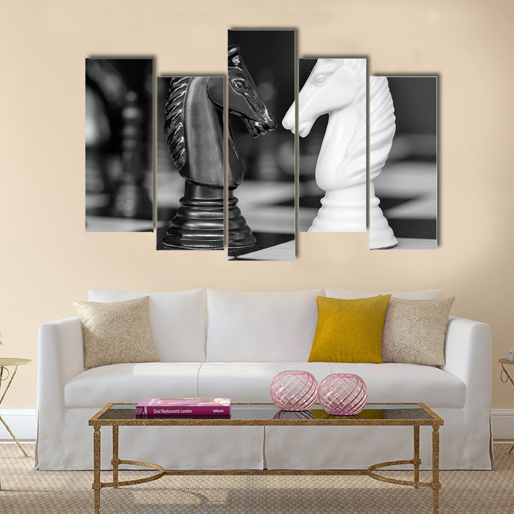 Chess knights head to head. Black and white image multi panel canvas wall art