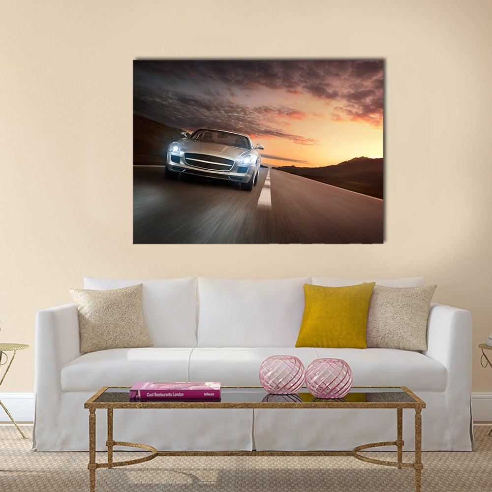 Luxury sports car speeding on a highway at the sunset Multi panel canvas wall art