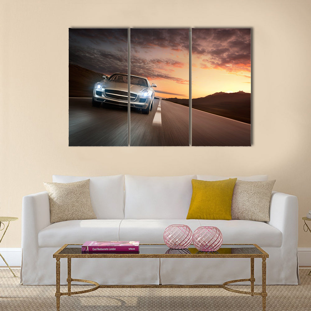 Luxury sports car speeding on a highway at the sunset Multi panel canvas wall art