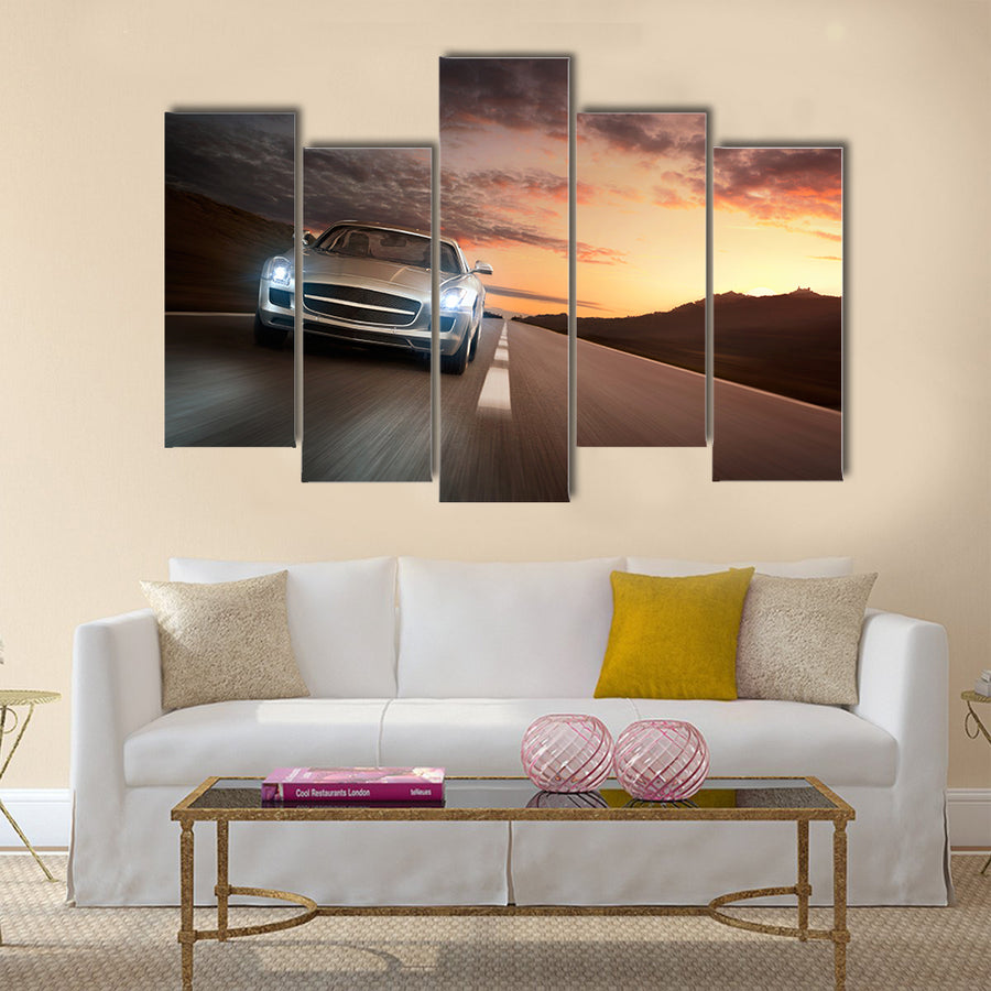 Luxury sports car speeding on a highway at the sunset Multi panel canvas wall art