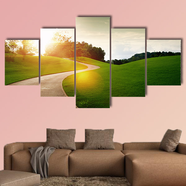 Panoramic view of nice green hill and path during sunset multi panel canvas wall art