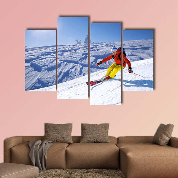Skier skiing downhill in high mountains Multi panel canvas wall art