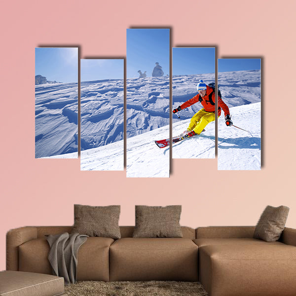 Skier skiing downhill in high mountains Multi panel canvas wall art
