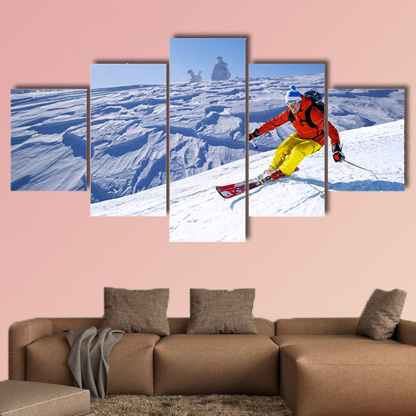 Skier skiing downhill in high mountains Multi panel canvas wall art