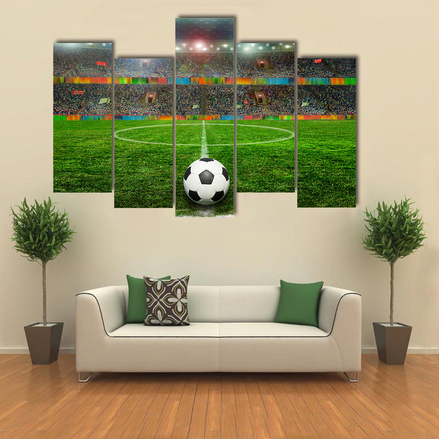 Soccer ball on the field of stadium with light Multi panel canvas wall art