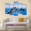 Jumping Dolphins, Blue Sea And Sky, White Clouds Multi Panel Canvas Wall Art