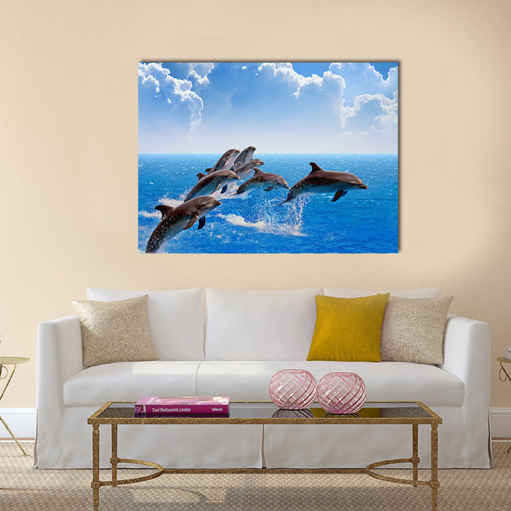 Jumping dolphins, blue sea and sky, white clouds Multi Panel Canvas Wall Art