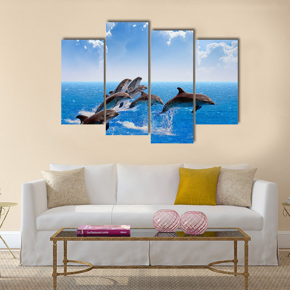 Jumping dolphins, blue sea and sky, white clouds Multi Panel Canvas Wall Art