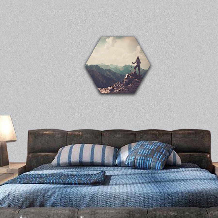 Woman hiker on a top of a mountain hexagonal canvas wall art