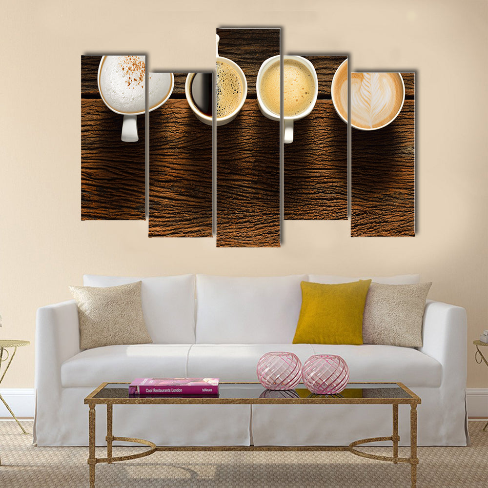 Variety of cups of coffee on old wooden table Multi Panel Canvas Wall Art