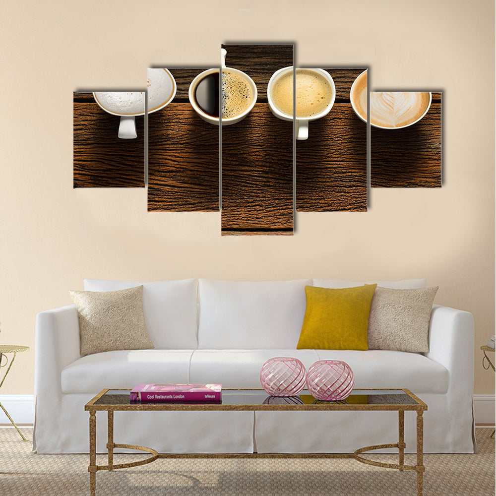 Variety of cups of coffee on old wooden table Multi Panel Canvas Wall Art