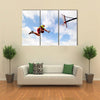 Young man jumping and playing street ball basketball Urban authentic Multi panel canvas wall art