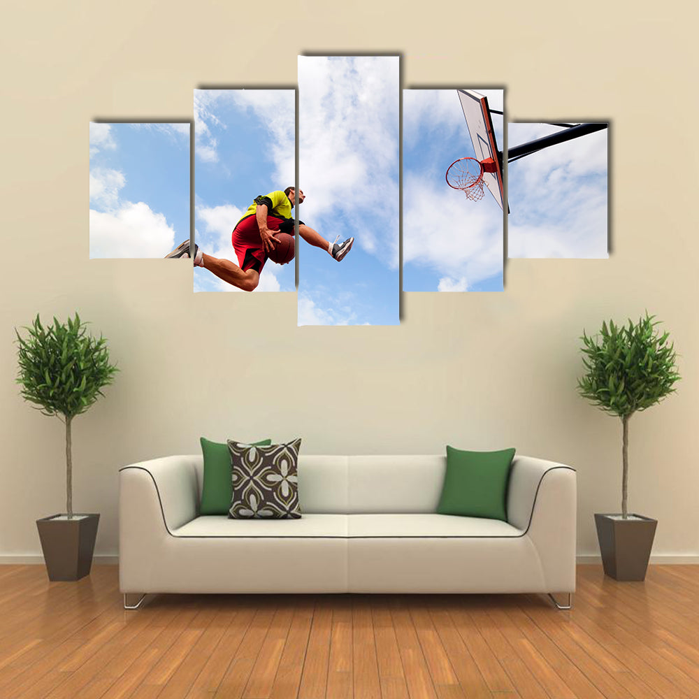 Young man jumping and playing street ball basketball Urban authentic Multi panel canvas wall art
