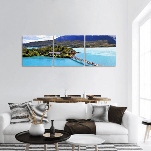 Island in lake Pehoe lake clouds cover cliffs of Los Kuernos panoramic canvas wall art