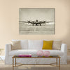 World War II era heavy bomber front view stained old photo Multi Panel Canvas Wall Art