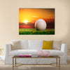 Golf ball on the lawn in sunset lights Multi Panel Canvas Wall Art