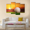 Golf ball on the lawn in sunset lights Multi Panel Canvas Wall Art