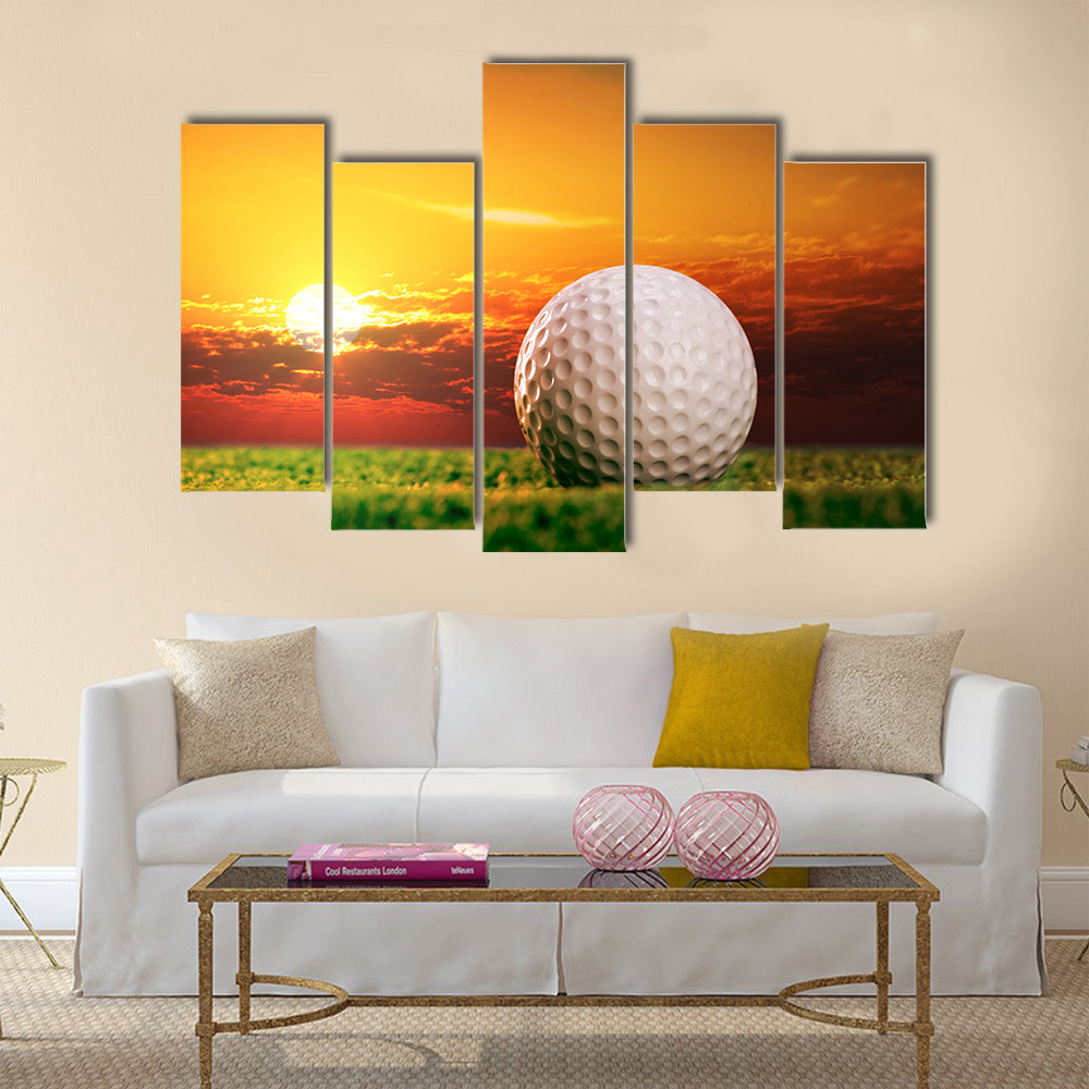 Golf ball on the lawn in sunset lights Multi Panel Canvas Wall Art