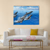 Graceful Jumping dolphins, blue sea and sky, white clouds Multi Panel Canvas Wall Art