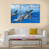 Graceful Jumping dolphins, blue sea and sky, white clouds Multi Panel Canvas Wall Art