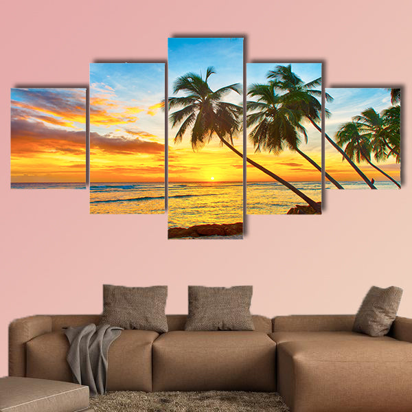 Beautiful sunset over the sea with a view at palms wall art