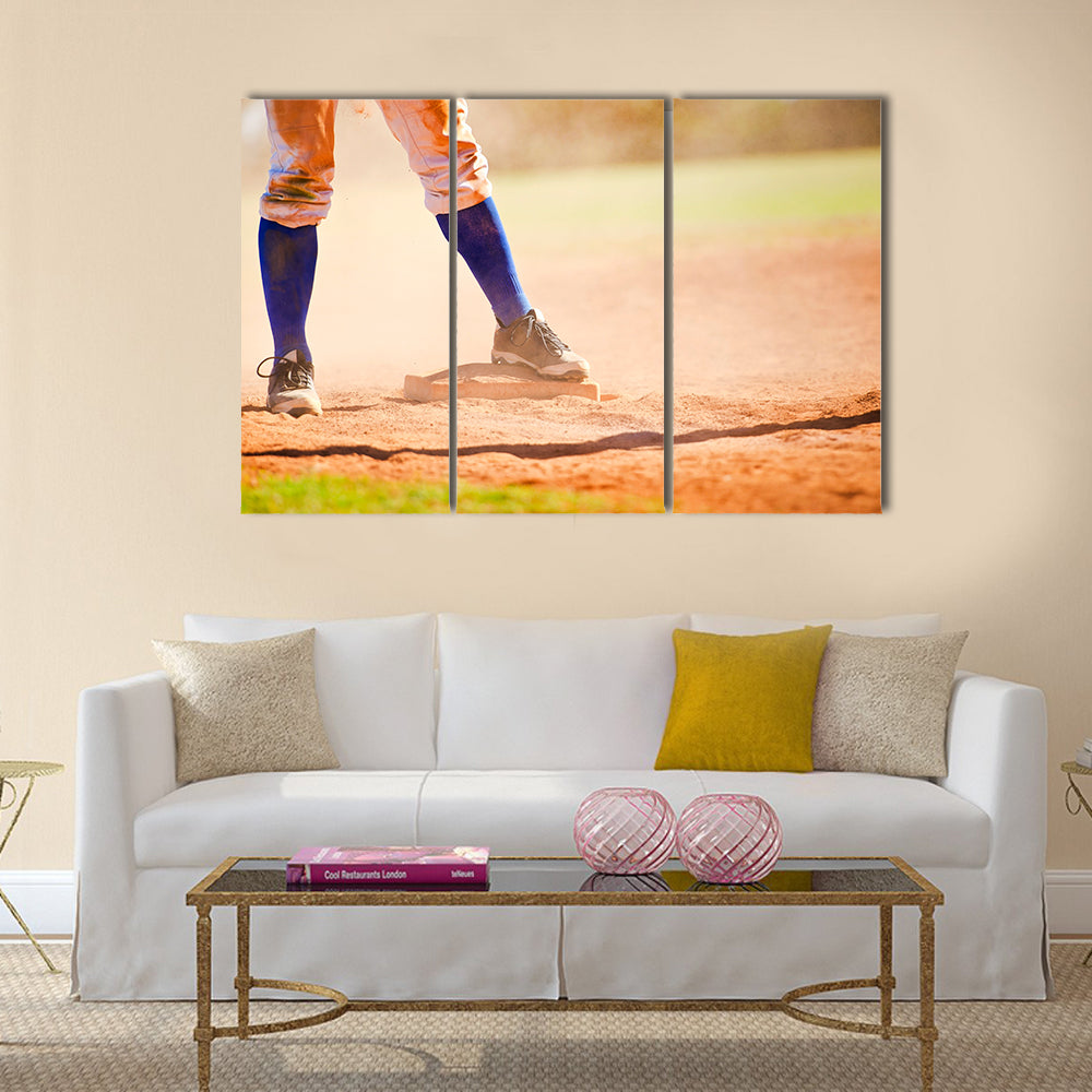 Baseball player wearing blue socks standing on a baseball base Multi panel canvas wall art
