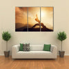 Asian man, fighter practices martial arts in high mountains at sunset Multi panel canvas wall art