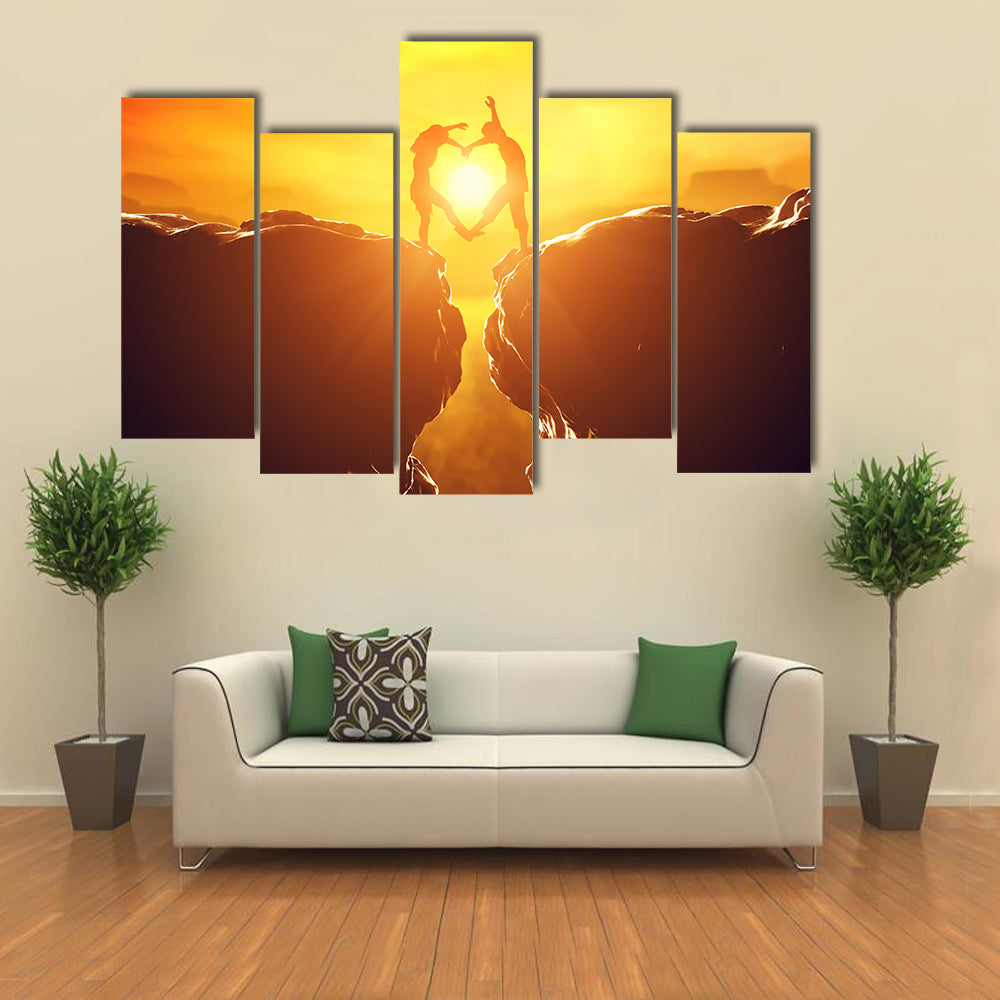 Happy couple making heart shape over precipice multi panel canvas wall art