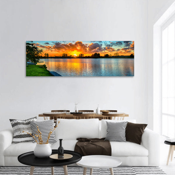 Sunset over a lake from land in the winter panoramic canvas wall art