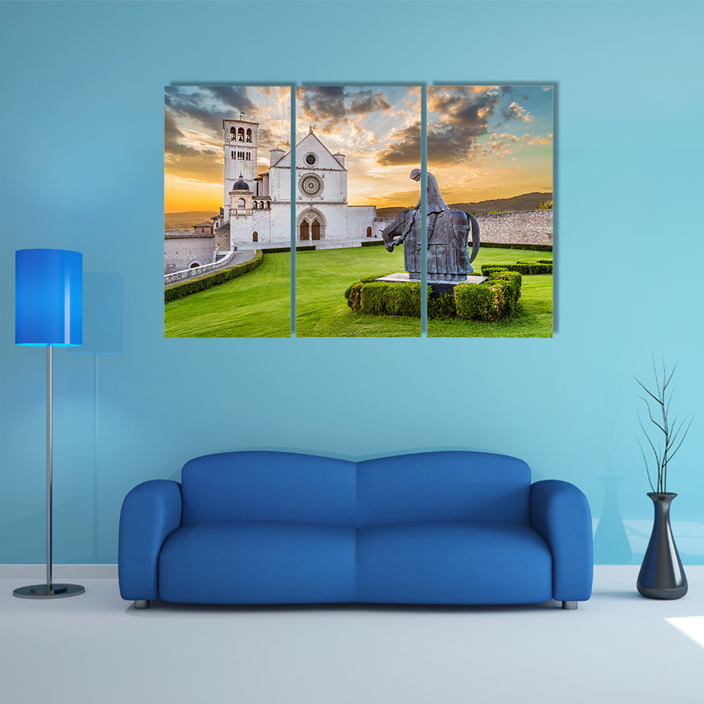 Famous Basilica of St Francis of Assisi with statue at sunset in Assisi, Umbria, Italy multi panel canvas wall art