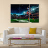 American football player in action on the stadium Multi panel canvas wall art