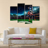 American football player in action on the stadium Multi panel canvas wall art