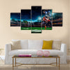 American football player in action on the stadium Multi panel canvas wall art