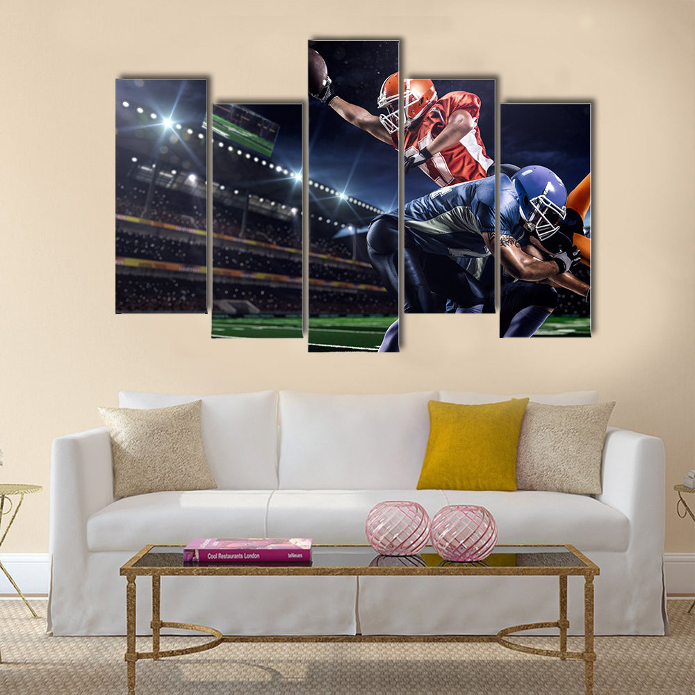 Strong American football player in action on the stadium Multi panel canvas wall art