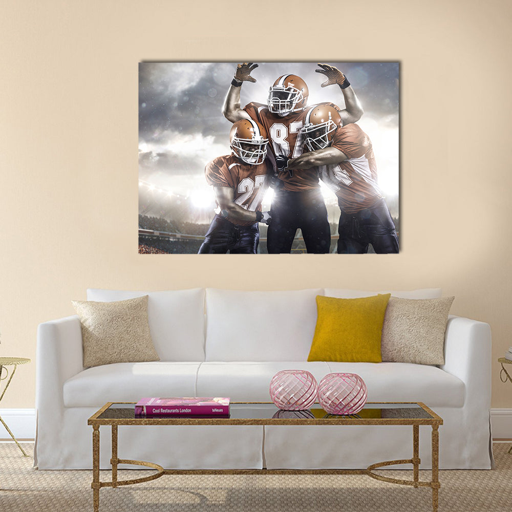 Three American football player in action on the stadium Multi panel canvas wall art