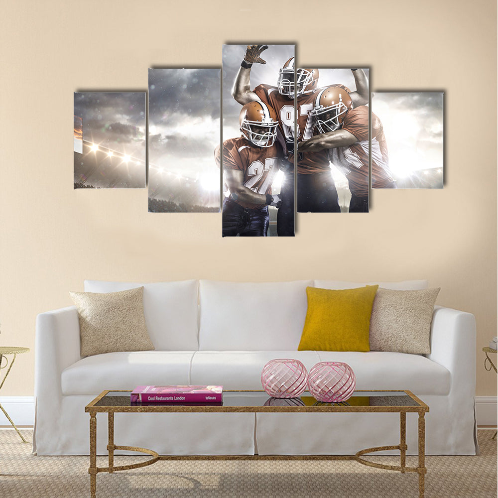 Three American football player in action on the stadium Multi panel canvas wall art