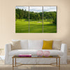 A golf green with bunkers with backdrop of trees Multi Panel Canvas Wall Art