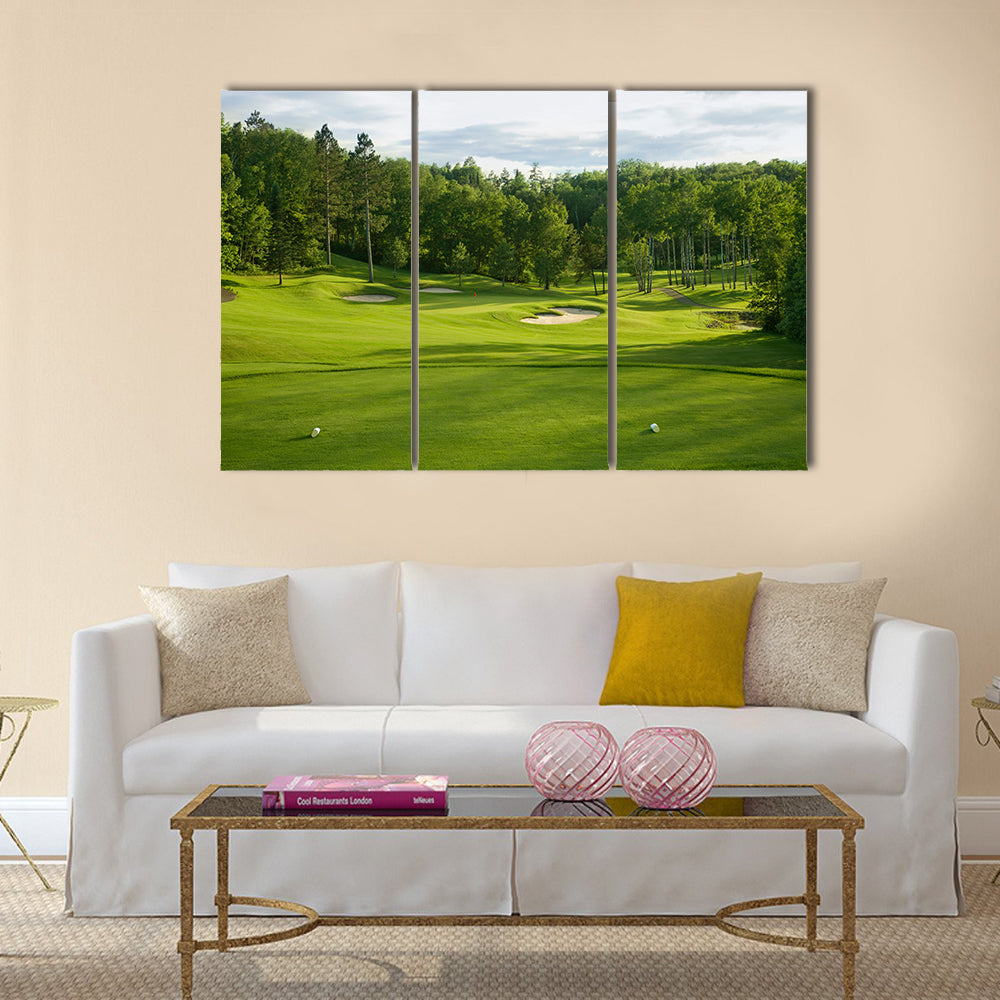 A golf green with bunkers with backdrop of trees Multi Panel Canvas Wall Art