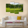 A golf green with bunkers with backdrop of trees Multi Panel Canvas Wall Art