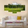 A golf green with bunkers with backdrop of trees Multi Panel Canvas Wall Art