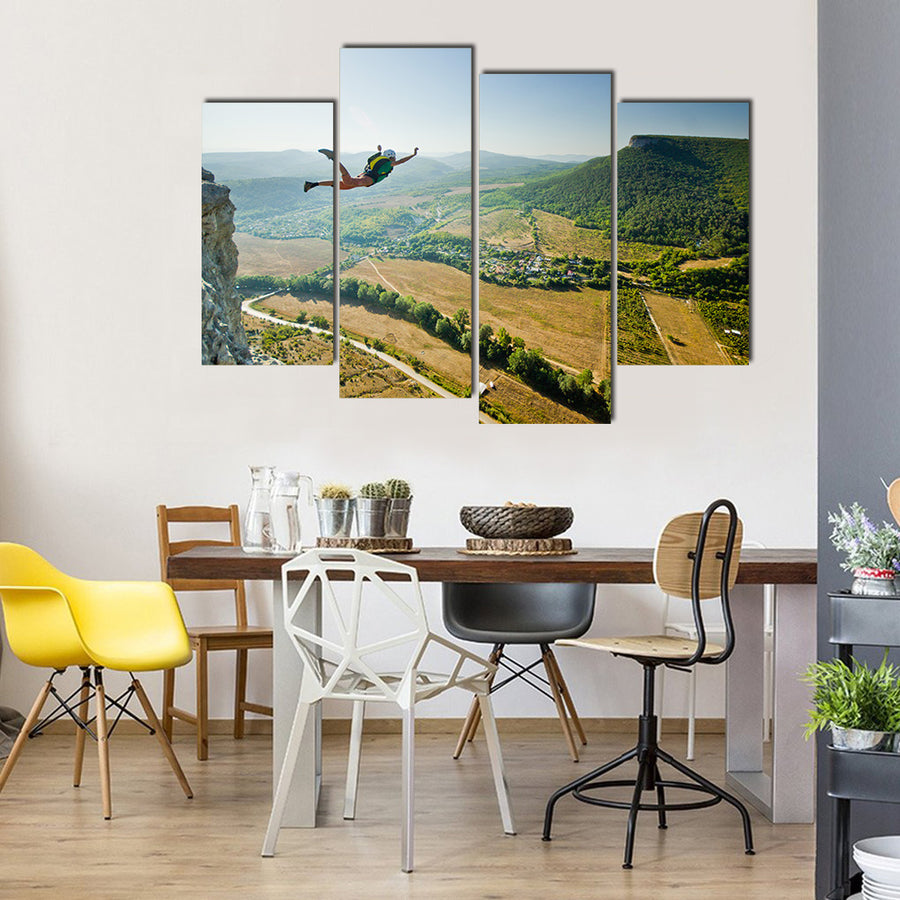 Base-jumper Jumps from the Cliff at Sunrise in the Mountains Multi Panel Canvas Wall Art