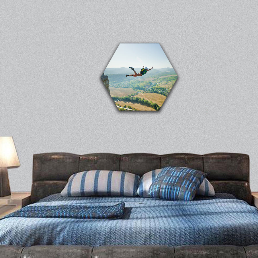 Jumper jumps from the cliff at sunrise hexagonal canvas wall art