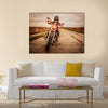 Biker girl in a leather jacket and helmet on a motorcycle Multi panel canvas wall art